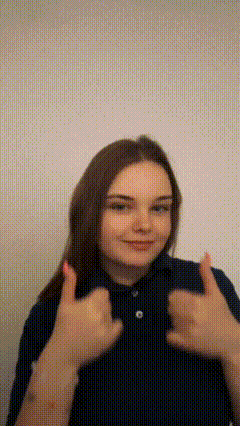 a girl in a black shirt is giving a thumbs up sign