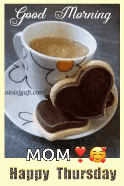 a cup of coffee and two cookies in the shape of a heart on a saucer with the words `` good morning mom happy thursday '' .