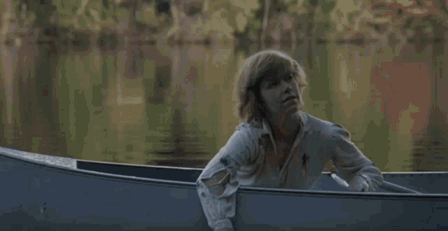 a person 's hand is visible on the side of a boat