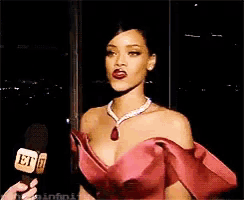a woman in a red dress is holding a microphone that says et