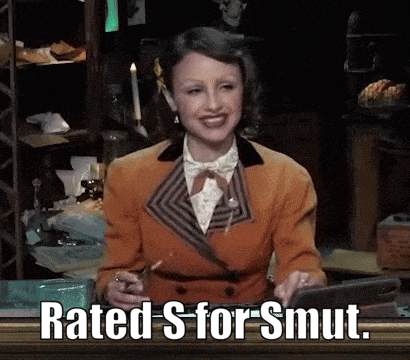 a woman in an orange suit is smiling and says rated s for smut .