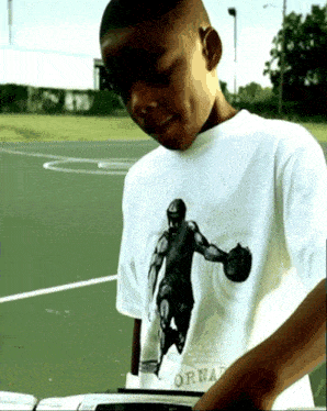 a young boy wearing a white shirt that says tornado