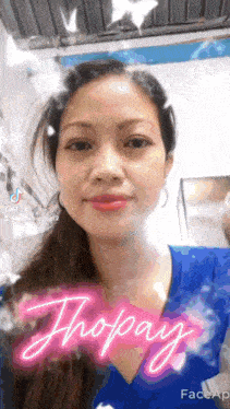 a woman in a blue shirt with the word thopay written on it