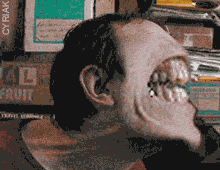 a pixelated image of a man 's face with a box of fruit behind him