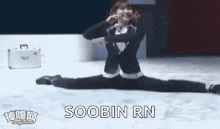 a person is doing a split on a ice rink with a suitcase in the background .