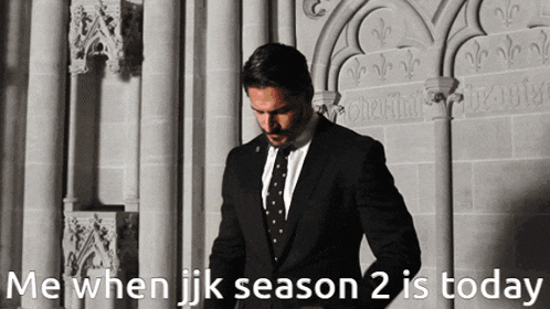 a man in a suit and tie is standing in front of a stone wall with the words me when jk season 2 is today