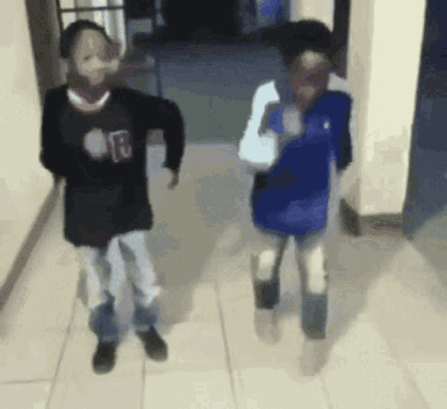 two people are dancing in a hallway with one wearing a shirt that says ' rb ' on it