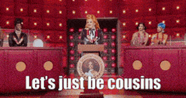 a drag queen stands at a podium with the words let 's just be cousins on the bottom