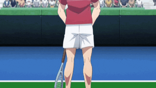 a man holding a tennis racket stands on a tennis court