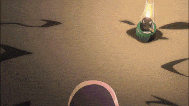 a lantern with a green base is sitting on the ground