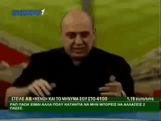 a man is sitting in front of a screen that says eurosport 1 on it