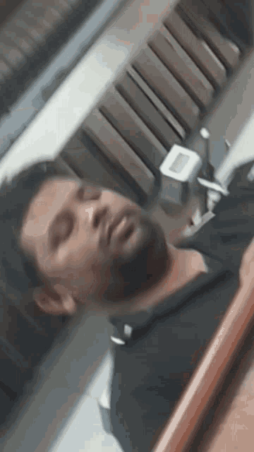 a man with a beard is sleeping in a room