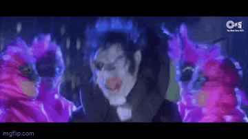 a man in a clown costume is surrounded by pink and purple birds .