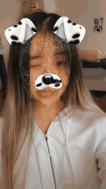 a girl wearing a dalmatian dog filter on her face