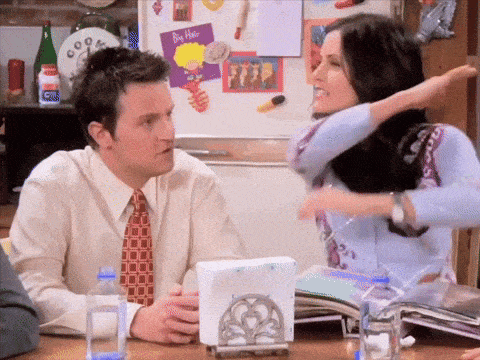 a man and a woman are sitting at a table with a napkin holder and a bottle of water ..