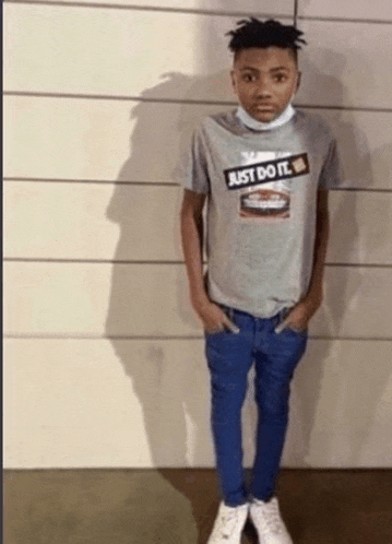 a young man wearing a just do it shirt