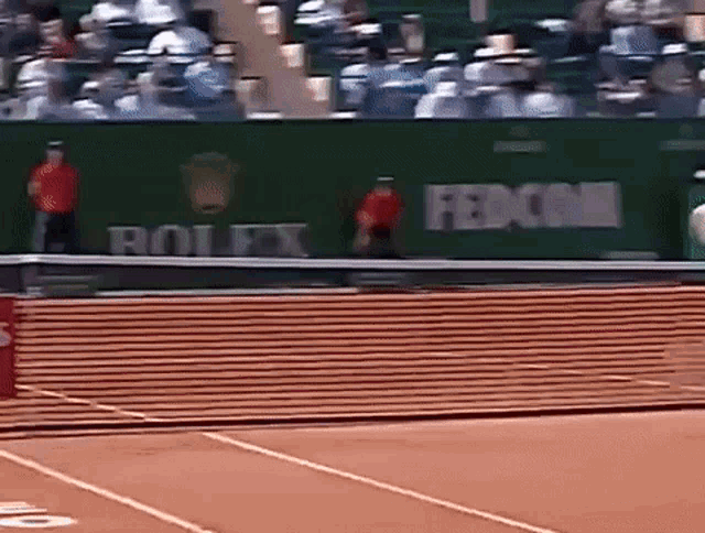 a tennis court with a rolex and fedcom sign