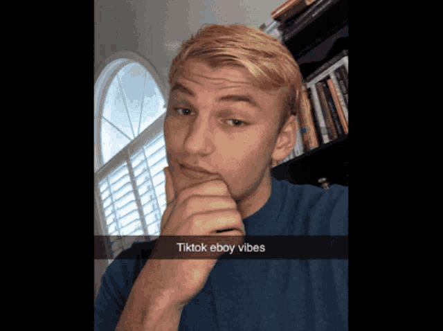 a young man taking a selfie with the caption tiktok eboy vibes