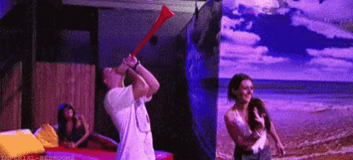 a man is blowing a horn at a woman in front of a beach .