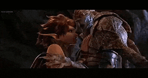 a man and a woman are kissing each other in a cave .