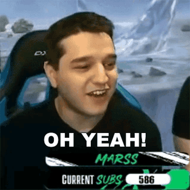 a man is sitting in a chair with the words `` oh yeah ! marss '' on the screen behind him .