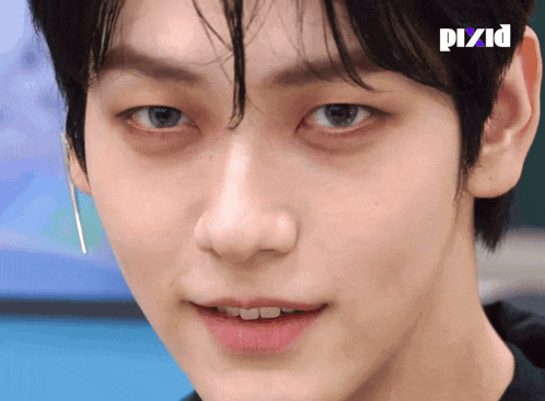 a close up of a person 's face with pixid written on the bottom right