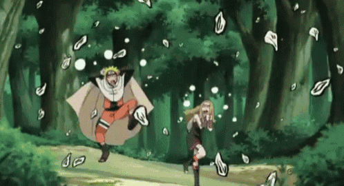 a man and a woman are running through a forest with leaves flying in the air .