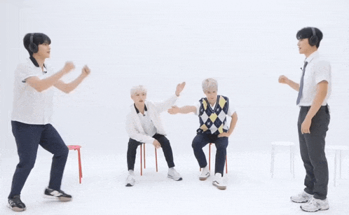 a group of young men are standing in front of a sign that says manifesting !!!