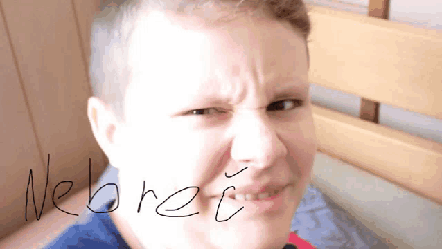a boy making a funny face with the word webret written on the bottom