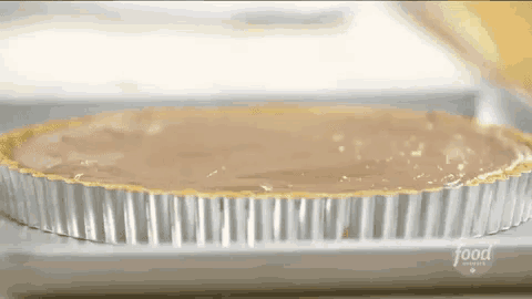 a pie in a tin foil pan with the word food on the bottom