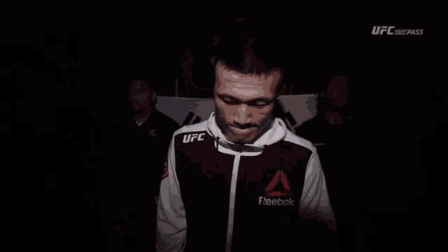 a man wearing a black and white reebok jacket