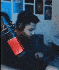 a close up of a red and blue microphone on a person 's arm .