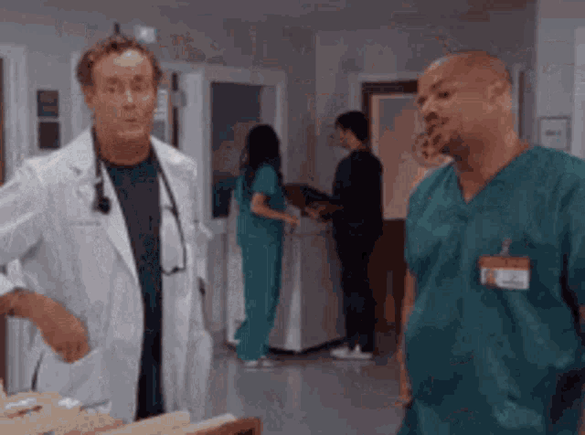 a doctor and a nurse are talking in a hospital