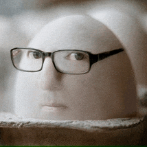 a statue of a man wearing glasses looks like a bald head