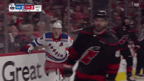 a hockey game is being played in front of an ad for great