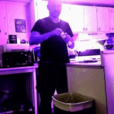 a man in a kitchen with a sign that says coffee