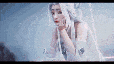 a woman with white hair and a white dress is sitting on a swing .