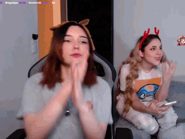 two girls are sitting in front of a screen that says diegoapez on it