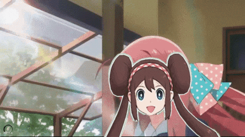 a girl with brown hair and blue eyes is laying on a bed in a room