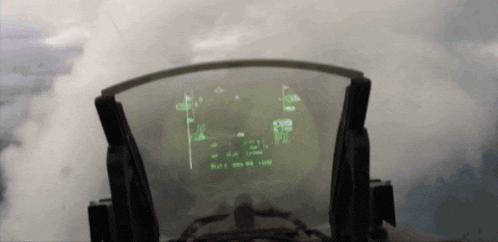 a cockpit view of a fighter jet flying through the clouds with a screen that says ' r ' on it