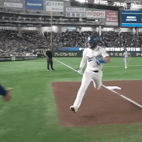 a baseball player for the dodgers is running to base