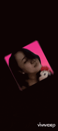 a woman holding a stuffed mickey mouse on a purple background