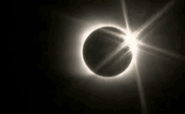 a total eclipse of the sun with the moon covering the sun