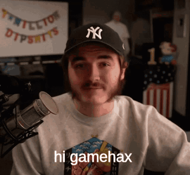 a man wearing a new york yankees hat and a t-shirt that says higamehax
