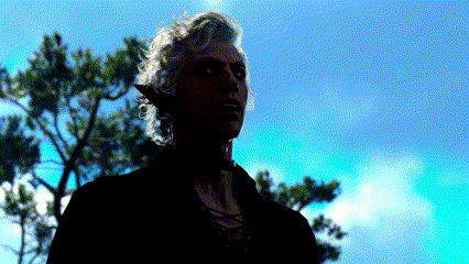 a silhouette of a person with a blue sky behind them