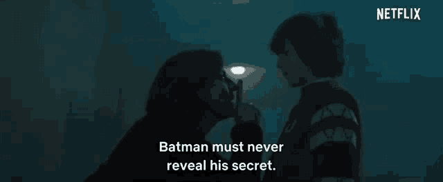 a man and a woman are kissing in a dark room .