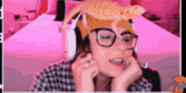 a woman wearing headphones and a hat with a lizard on it