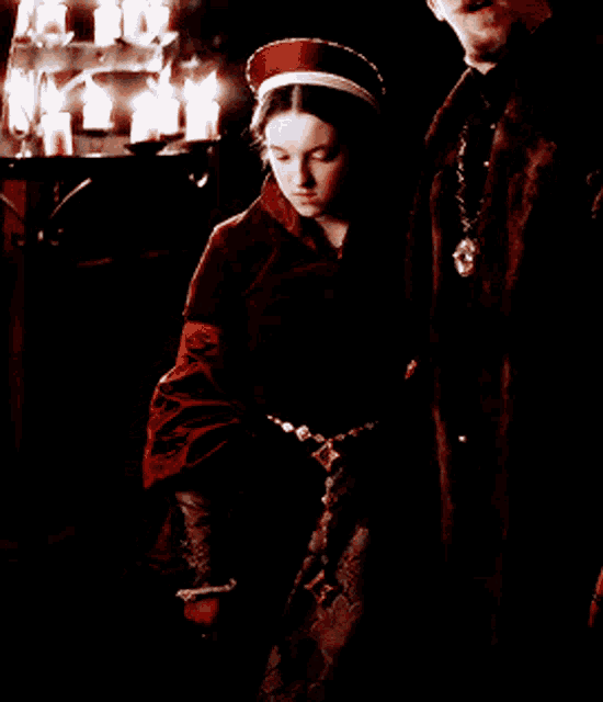 a man and a woman standing in front of a candle holder