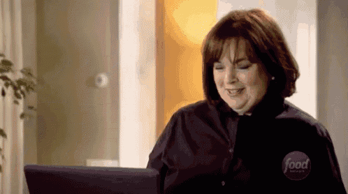 a woman is using a laptop computer and smiling .