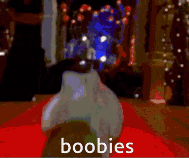 a blurry picture of a christmas tree with the word boobies in the corner